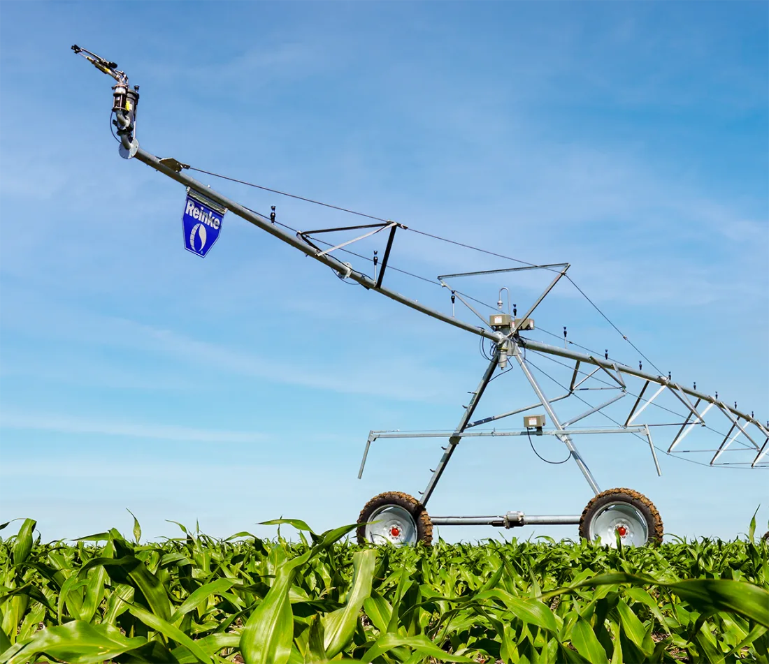 Reinke center pivot tower and span in a growing field