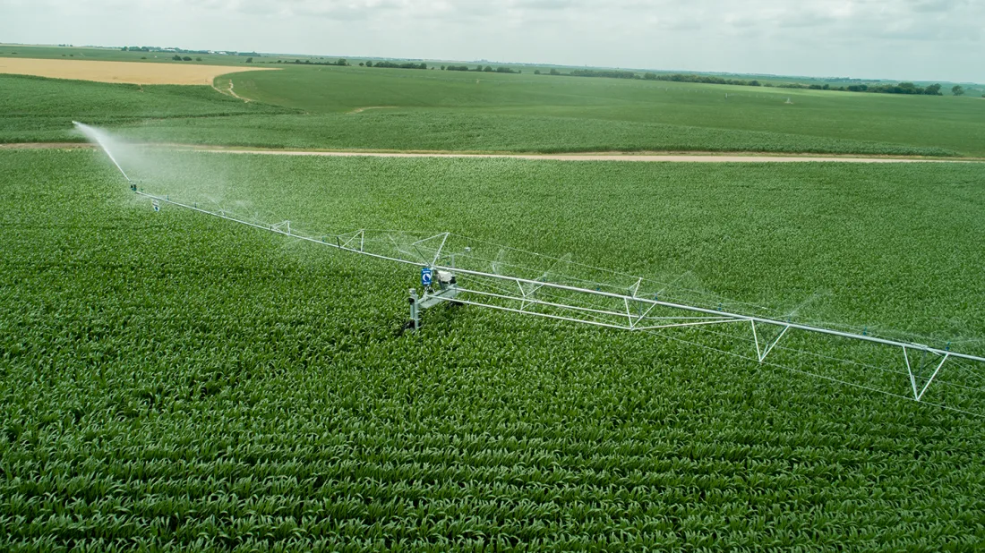 Aerial view of a Reinke swing-arm corner system irrigating a green field